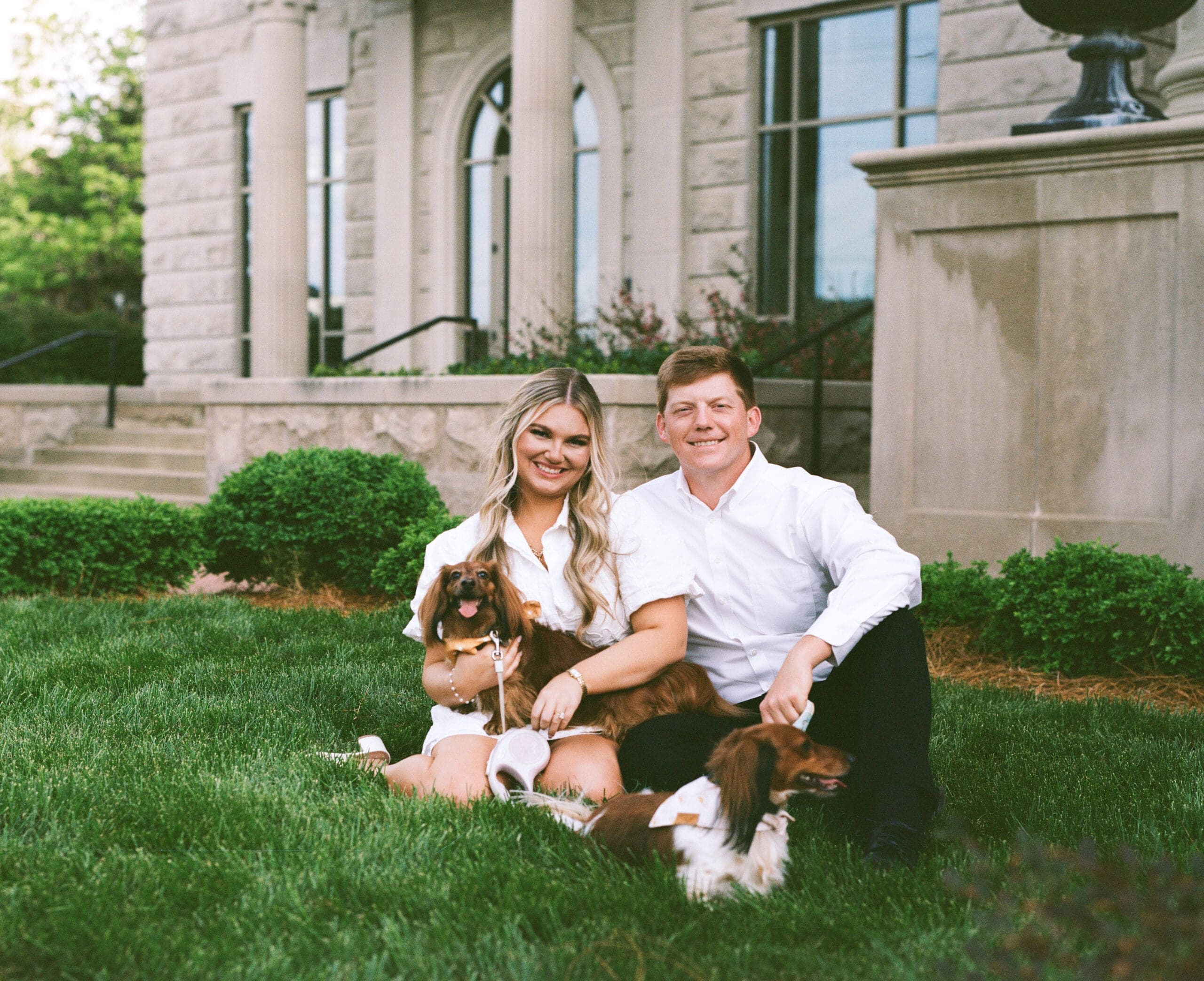Katie and Matt embracing in front of the Parthenon columns during their Nashville engagement session — captured on 35mm film by O Happy Day Photography