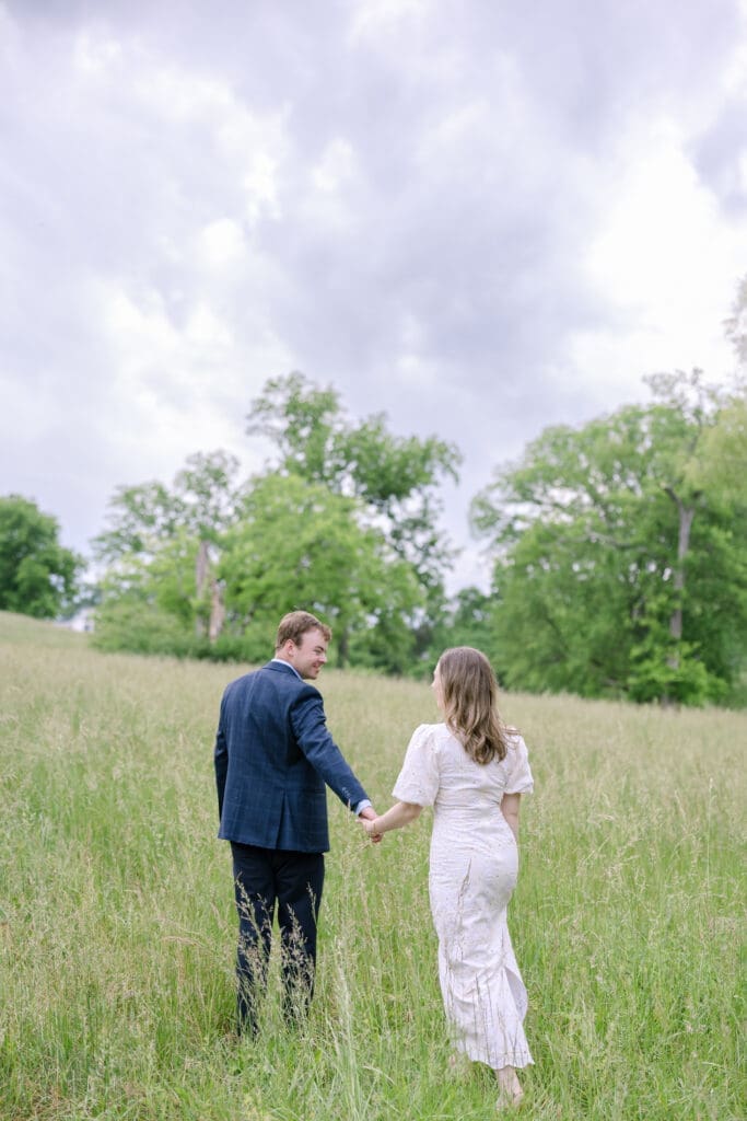 Wide shot of engaged couple in lush outdoor setting during Nashville spring engagement photography