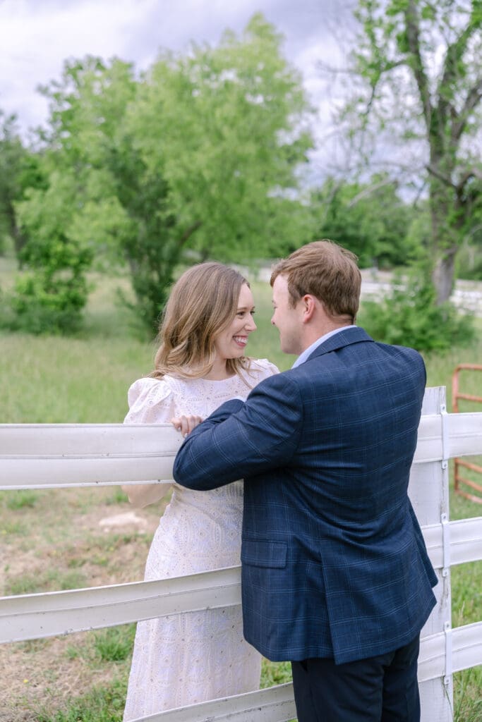 Couple leaned up on a fence sharing a special moment together at their destination Nashville engagement session