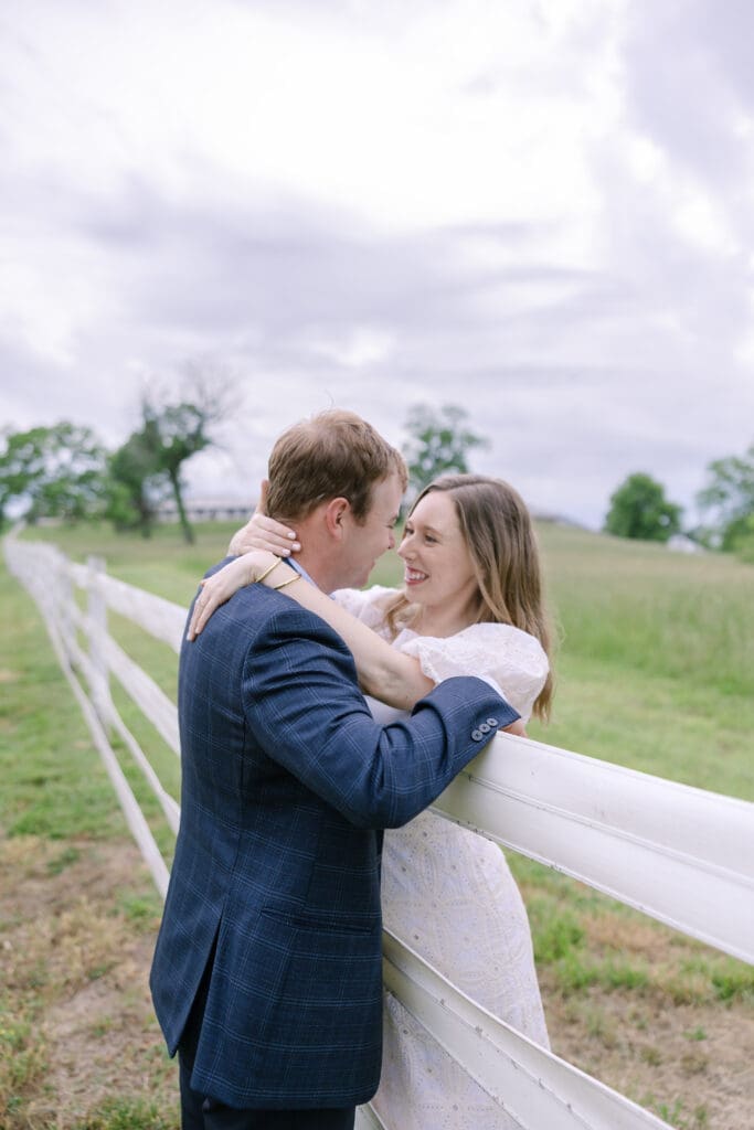 Couple leaned up on a fence sharing a special moment together at their destination Nashville engagement session