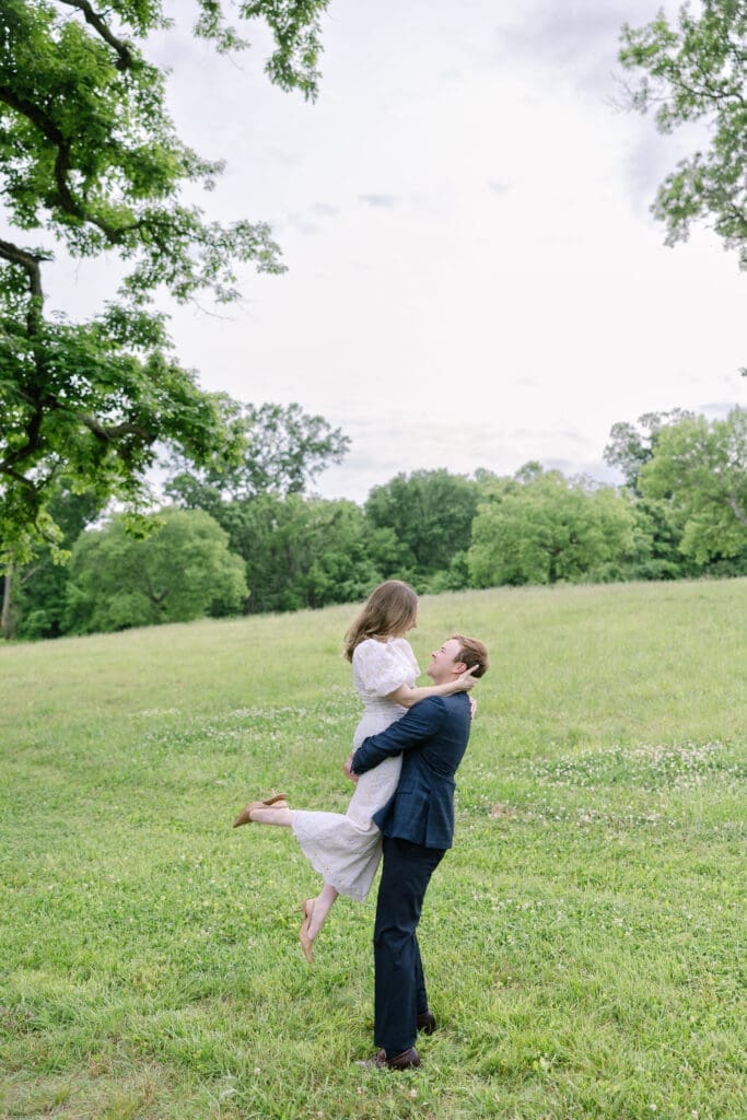 Wide shot of engaged couple in lush outdoor setting during Nashville spring engagement photography