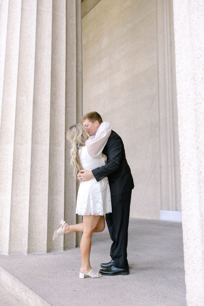 Katie in her first engagement outfit posing with Matt at the Parthenon Nashville captured on 35mm film