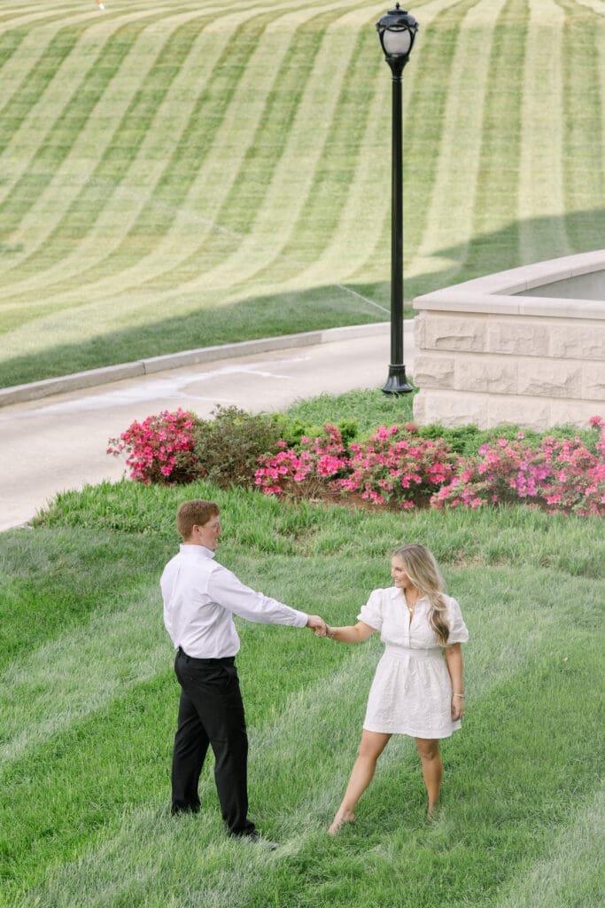 Candid moment between engaged couple on the lawn at Centennial Park Nashville