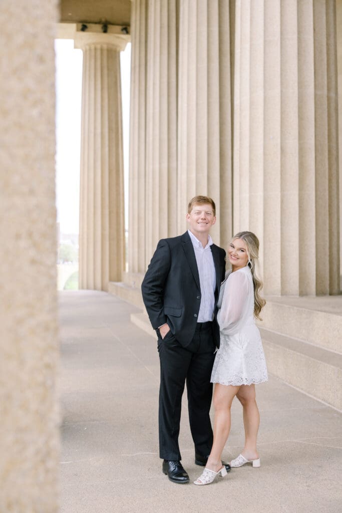 Katie in her first engagement outfit posing with Matt at the Parthenon Nashville captured on 35mm film