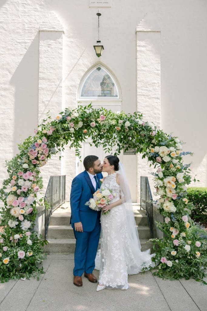 Intimate catholic ceremony at St. Phillips in Franklin, TN infront of beautiful floral arch by Tulia Grace Florals