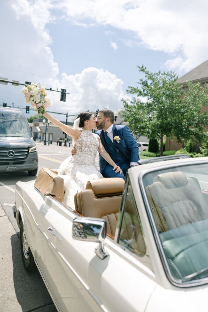 bride and groom drive away in classic rolls royce in their intimate franklin, tn wedding at cj's off the square