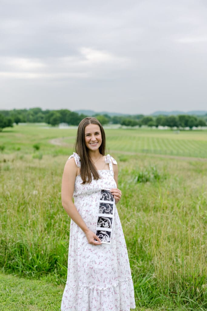 mom to be holding ultrasound of her son