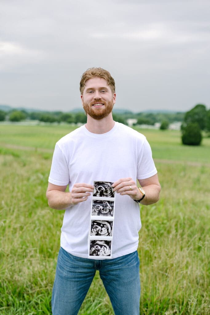dad to be holding ultrasound of his son