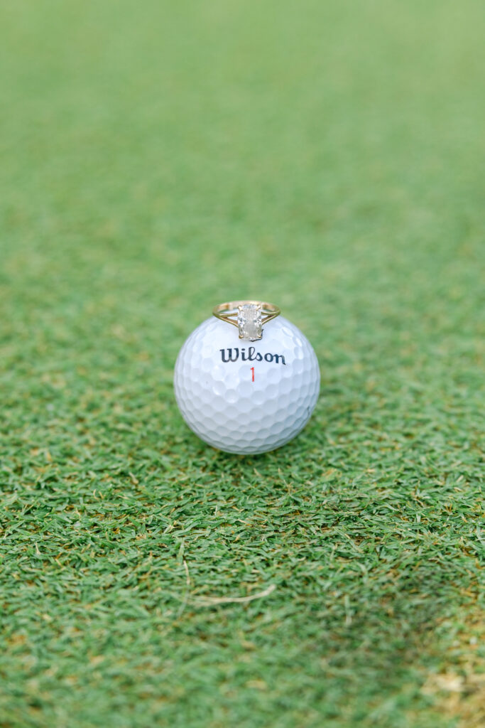 engagement ring on golf ball
